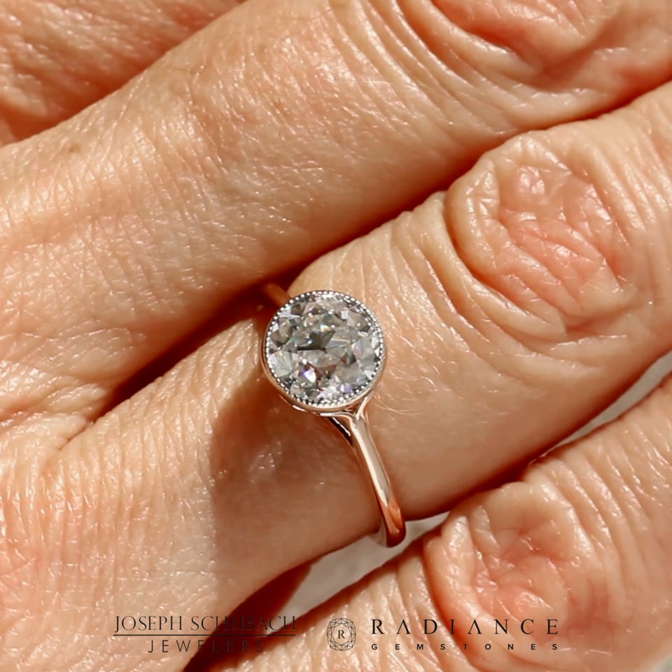 Style 103344: Bezel Set Scroll Solitaire Engagement Ring with a Surprise Diamond Accent