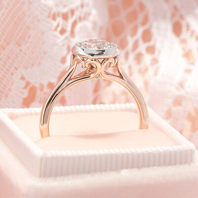 Style 103344: Bezel Set Scroll Solitaire Engagement Ring with a Surprise Diamond Accent