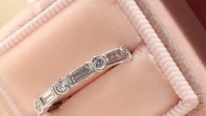 Style 103373: The Kate bezel set baguette and round diamond wedding band with hand engraving.