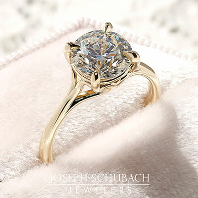 Style 102783: Round Scroll Solitaire Engagement Ring with a Surprise Diamond Accent